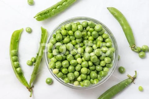Raw Peas in Glass Bowl, Isolated on White Background, Top View Stock Photos