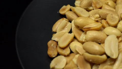 Raw peeled peanuts fried with salt.  Rotation. Snack closeup. Peanuts in a bowl. Stock Footage 102207147