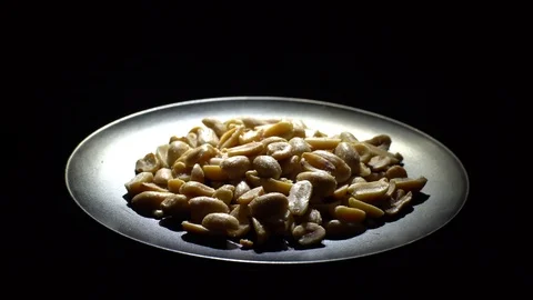 Raw peeled peanuts fried with salt.  Rotation. Snack closeup. Peanuts in a bowl. Stock Footage 102207227