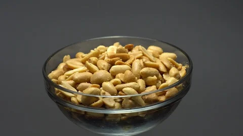 Raw peeled peanuts fried with salt.  Rotation. Snack closeup. Peanuts in a bowl. Stock Footage 102234603