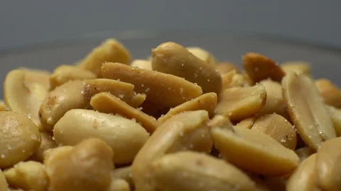 Raw peeled peanuts fried with salt.  Rotation. Snack closeup. Peanuts in a bowl. Stock Footage 102235165