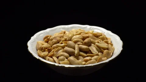 Raw peeled peanuts fried with salt. Rotation. Snack closeup. 動画素材 102235678
