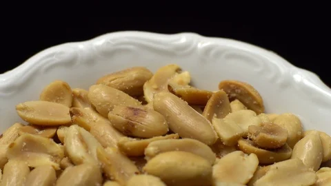 Raw peeled peanuts fried with salt.  Rotation. Snack closeup. Peanuts in a bowl. Stock Footage 102235681