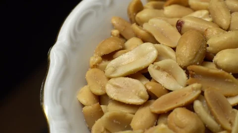 Raw peeled peanuts fried with salt.  Rotation. Snack closeup. Peanuts in a bowl. Stock Footage 102235752
