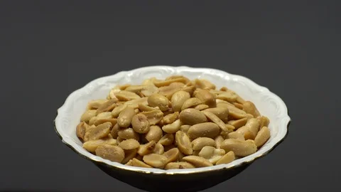 Raw peeled peanuts fried with salt.  Rotation. Snack closeup. Peanuts in a bowl. Stock Footage 102236090