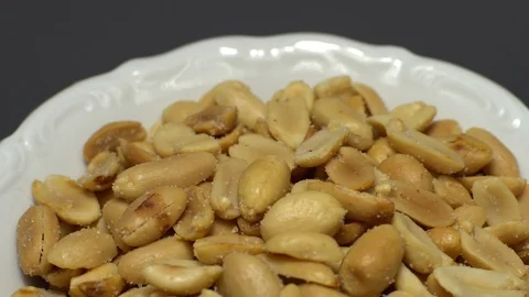 Raw peeled peanuts fried with salt.  Rotation. Snack closeup. Peanuts in a bowl. Stock Footage 102236162