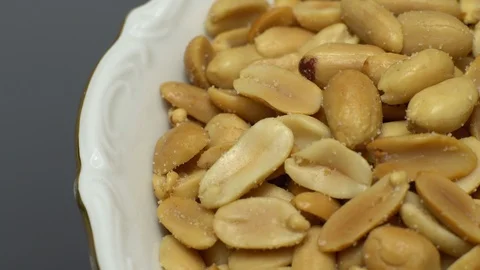 Raw peeled peanuts fried with salt.  Rotation. Snack closeup. Peanuts in a bowl. Video stock 102236494