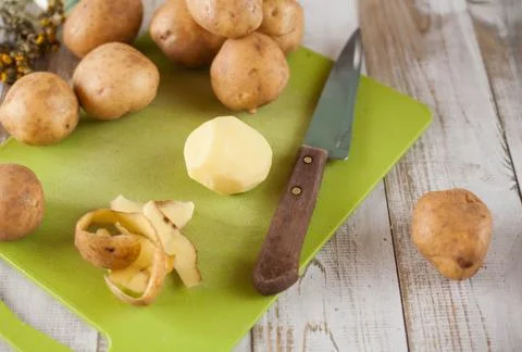 Raw peeled potatoes Stock Photos
