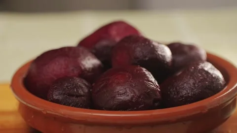 Raw peeled vegetable beet in plate on wooden table close-up. Preparing raw Stock Footage 270186661
