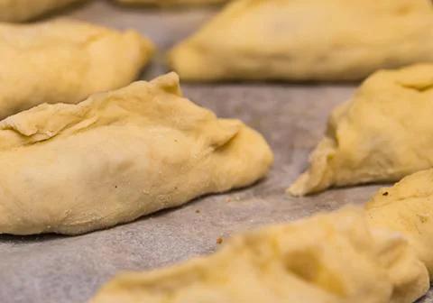 Raw pie billet thin dough with minced meat close-up, part of the product home Stock-Fotos