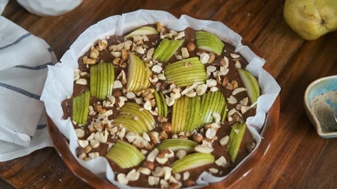 Raw pie with pear and nuts on the table Video stock 127540652