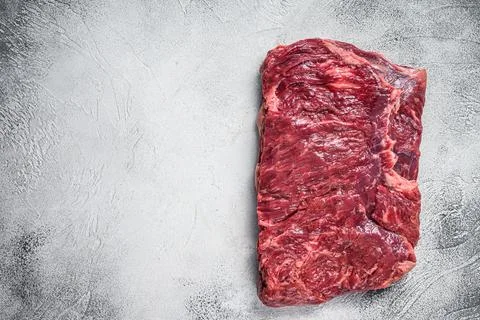 Raw piece of marble beef brisket meat. White background. Top view. Copy space Stock Photos