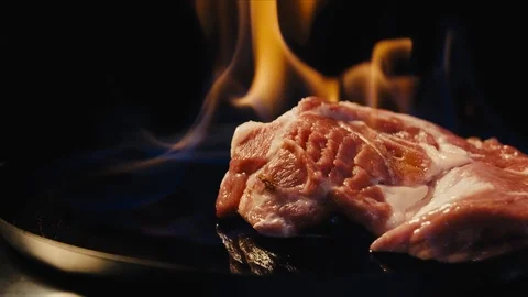 Raw piece of meat is fried in a pan Stock Footage 118133986