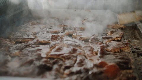 Raw pieces of meat is fried on baking sheet. Cooking meat grill in restaurant Stock Footage 111460538