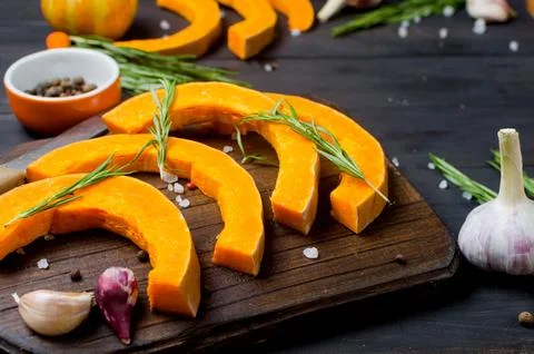 Raw pieces of pumpkin prepared for baking in the oven. Stock Photos