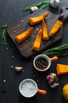 Raw pieces of pumpkin prepared for baking in the oven. Stock Photos