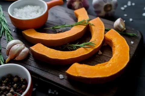 Raw pieces of pumpkin prepared for baking in the oven. Stock Photos
