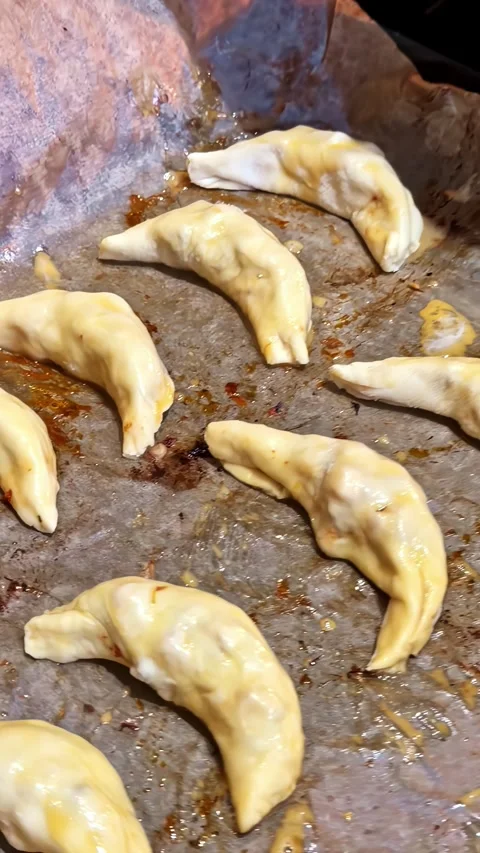 Raw Pierogi on Baking Tray Being Placed into Oven with Kitchen Towel Close Up Stock Footage 337195639