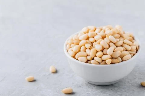 Raw pine nuts in bowl Stock Photos