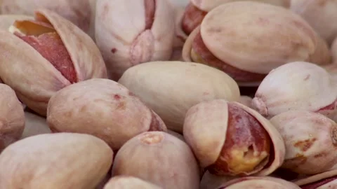 Raw pistachio nuts moving into frame Stock Footage 338160792