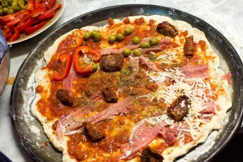 Raw pizza and ingredients Stock Photos