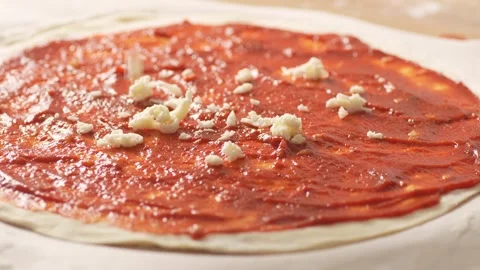 Raw pizza base with tomato sauce and cheese. Stock Footage 270535386