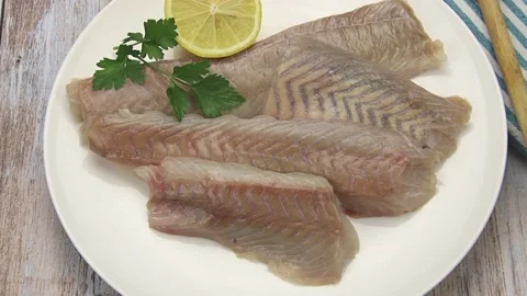 Raw pollack fillet isolated on a plate Stock Footage 166801586