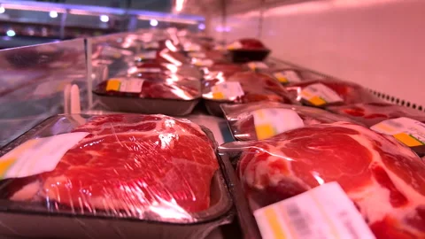 Raw pork and beef steaks in plastic containers covered with cling-wrap in fridge Video stock 248338347