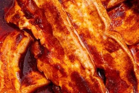 Raw pork belly marinating with bold barbecue rub spices Stock Photos