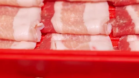 Raw Pork Belly Meat Slices with Marbled Fat Layers and Alternating Red Meat Stock Footage 346328059
