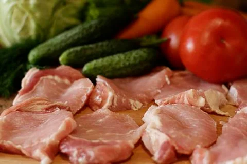Raw pork chops and vegetables Stock Photos
