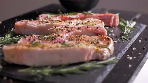 Raw pork chops with bone flavored with a mix of spices Stock Footage 106471013