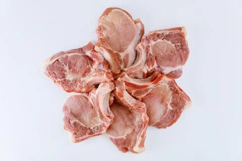 Raw pork chops bone in isoladet on white background. Stock Photos