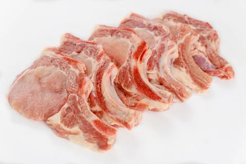 Raw pork chops bone in isoladet on white background. Stock Photos