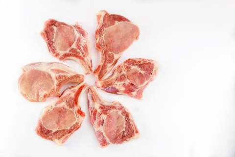 Raw pork chops bone in isolated on white background. Stock Photos