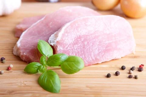 Raw pork chops on cutting board Stock Photos