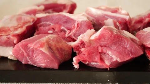 Raw pork cuts on dark surface close-up with soft focus motion. Vídeos de archivo 331927384