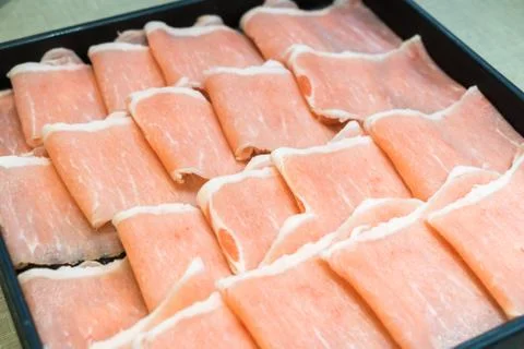 Raw pork in the dish wait to get down boiling in hot pot Stock Photos