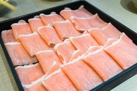 Raw pork in the dish wait to get down boiling in hot pot Foto stock