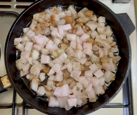 Raw pork fat rendering in hot pan Stock Footage 310268364