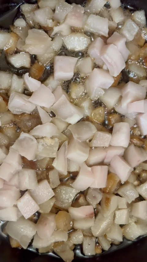 Raw pork fat rendering in hot pan Stock Footage 310268371