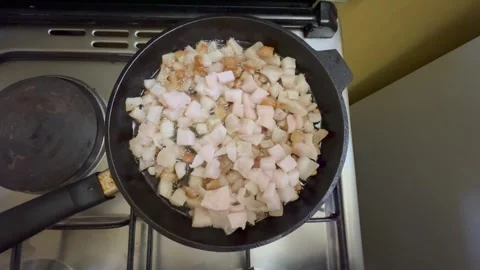 Raw pork fat rendering in hot pan Stock Footage 310268372
