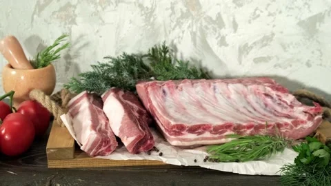 Raw pork loin, bacon with ribs on a wooden board Video stock 198736167
