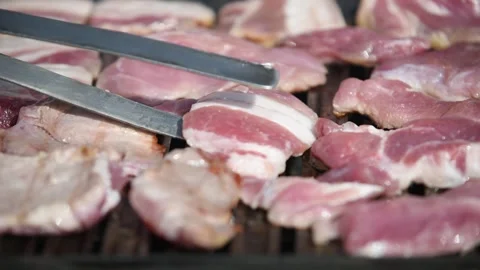 Raw pork meat on barbeque close up Stock Footage 335692546