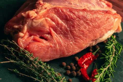 Raw pork meat with spices on slate stone kitchen board Stock Photos