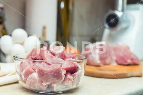 Raw pork neck meat cut in slices on glass bowl Stock Photos