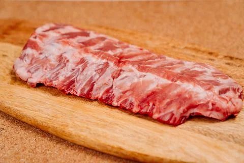 Raw pork ribs on a wooden cutting board. butcher shop. Stock Photos