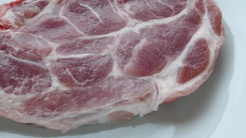 Raw pork is sprinkled with red pepper Stock Footage 98194422