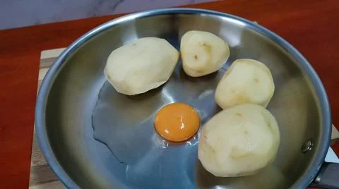 Raw Potatoes and Egg Stock Photos