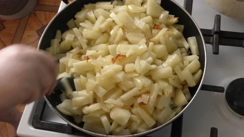 Raw potatoes are fried in a pan Stock Footage 164279855